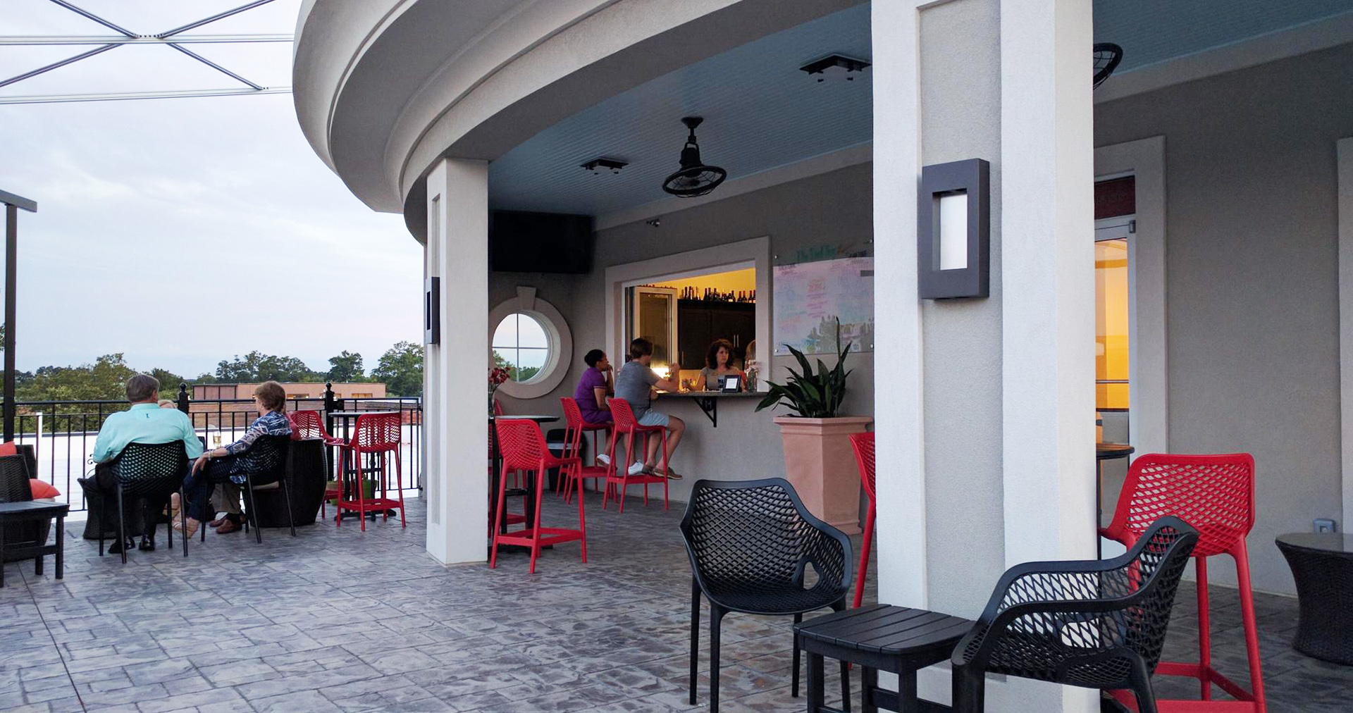 Rooftop lounge seating area with low tables and warm evening light