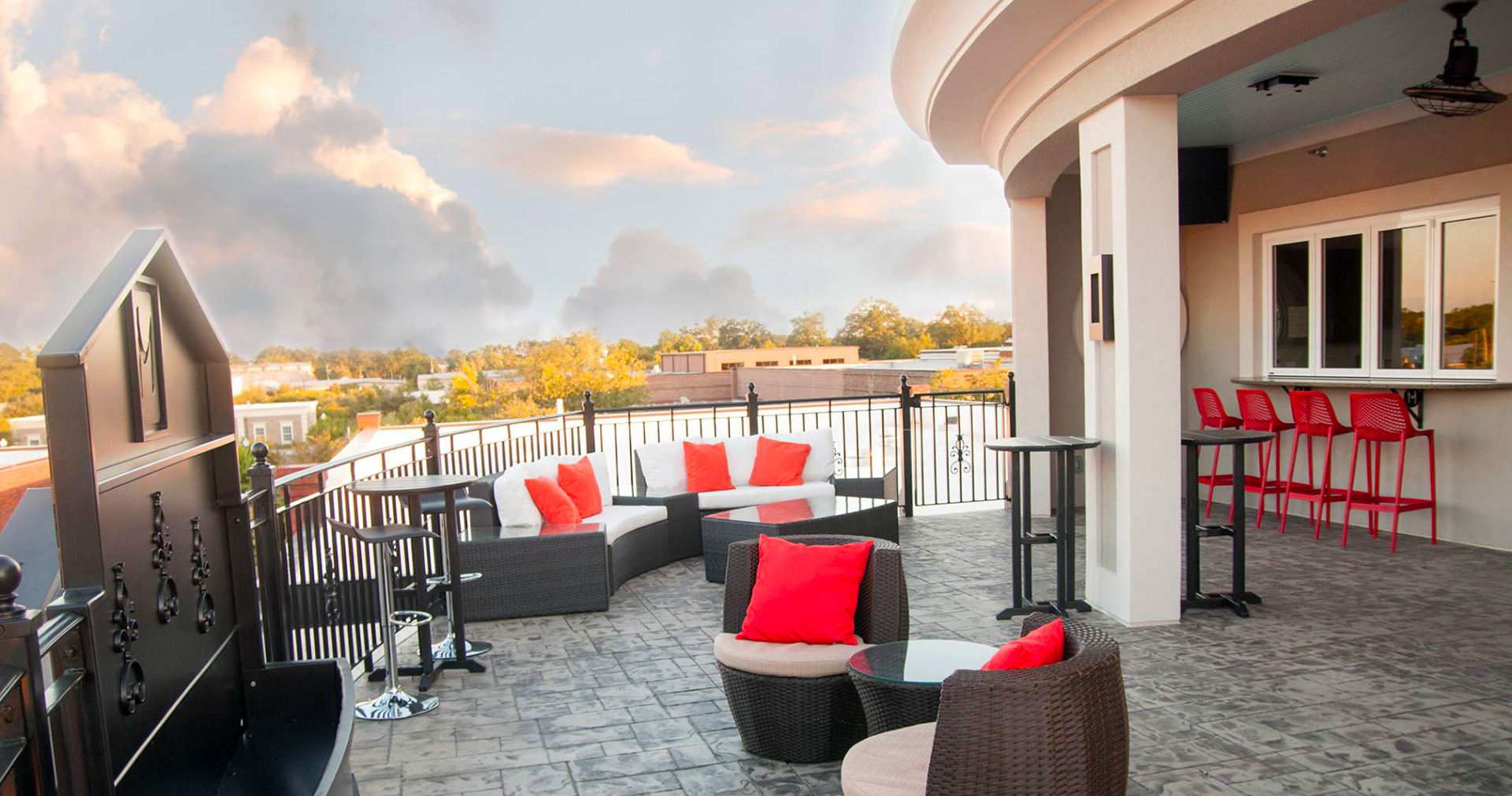 Sunset light across The Rooftop at the Mantissa, with lounge seating above downtown Hartsville