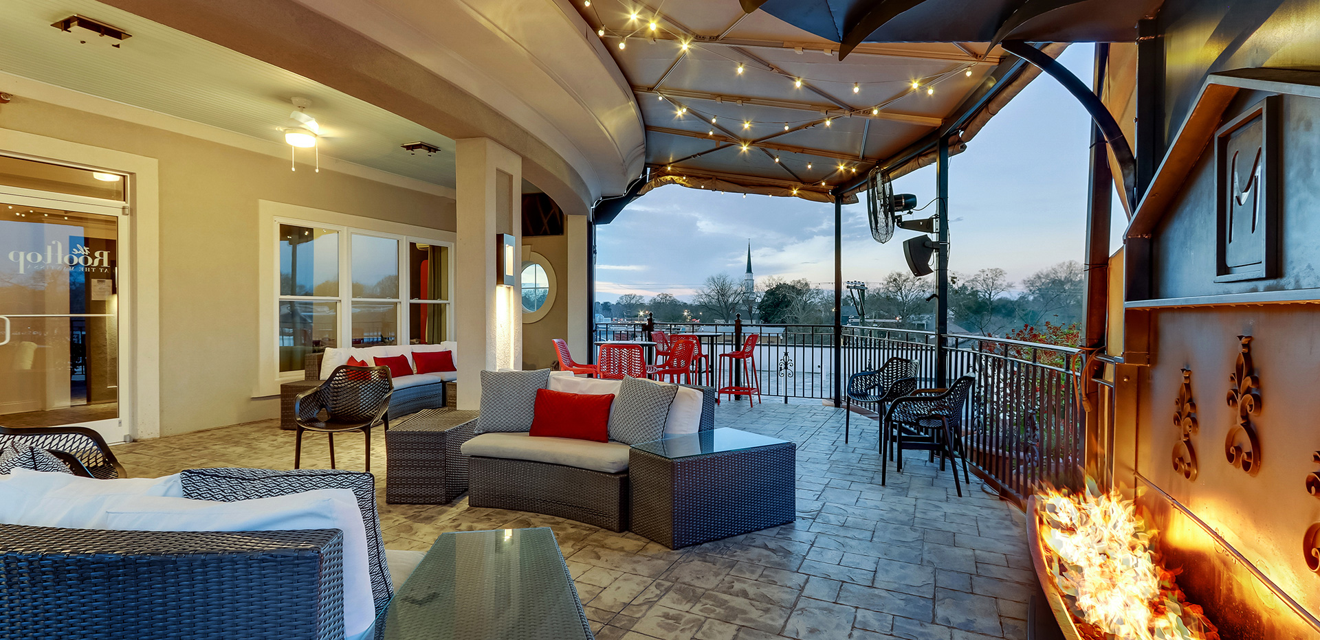 Empty rooftop after service, golden-hour light raking across the deck
