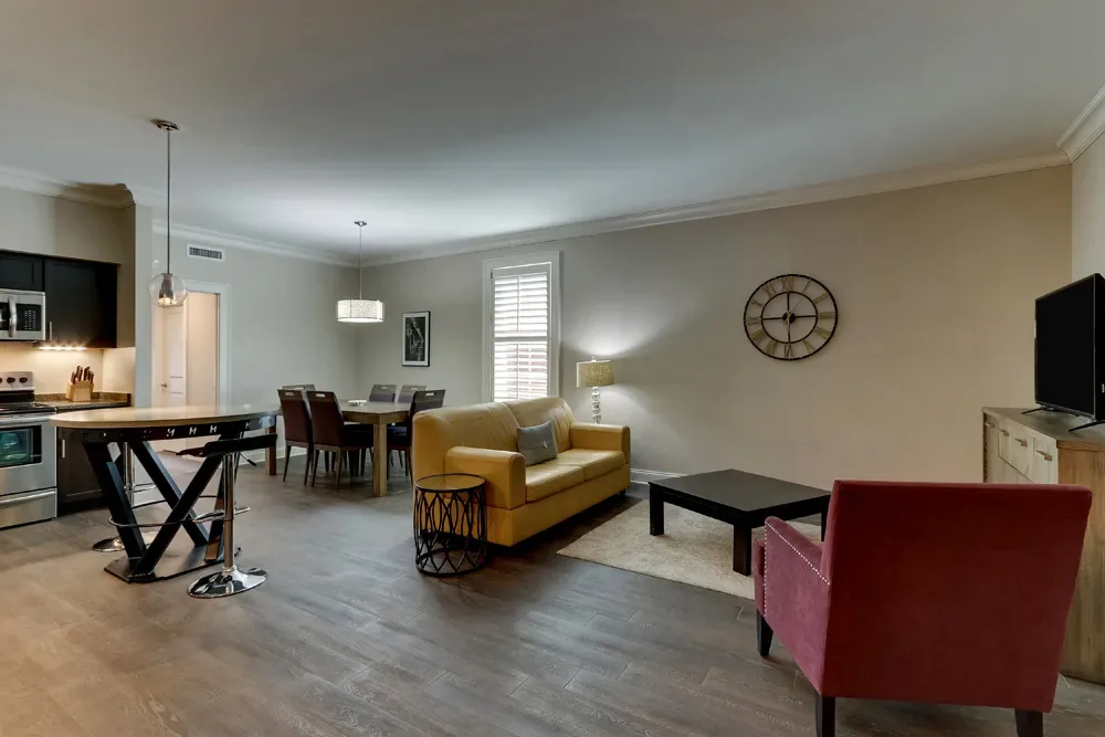 The Deluxe King's living and dining room, seating beside the full kitchen and dining table.